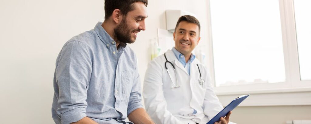 A direct primary care doctor and his patient sitting and talking